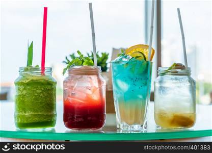 variety of iced fruit juice cocktail and mocktail on glass table