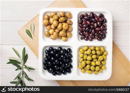 Variety of olive appetizer. Green black aragon and split olives. Tasty mediterranean food