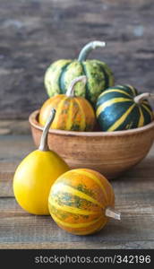 Variety of ornamental pumpkins on the wooden background