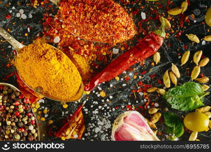 Variety of spices and herb on kitchen table.. Variety of spices and herbs on kitchen table. Flat lay, top view.