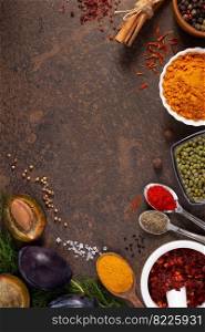 Variety of spices and herbs on table background. Cooking concept and ingredients at table top view