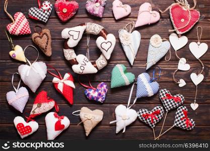 Variety of textile and wooden hearts on the holiday market. Valentine day. Variety of handmade hearts
