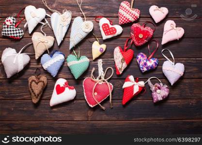 Variety of textile and wooden hearts on the holiday market. Valentine day. Variety of handmade hearts