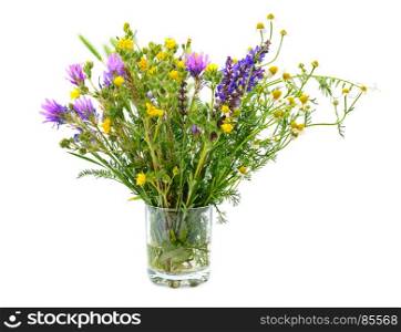 Variety of wild flowers in a glass isolated on white background.