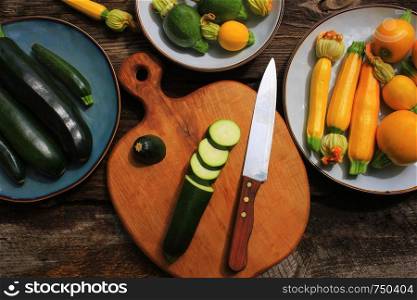 Variety zucchini, squash on a wooden background, top view. Vegetarian diet food concept. Cooking ingredients .. Variety zucchini, squash on a wooden background, top view. Vegetarian diet food concept. Cooking ingredients