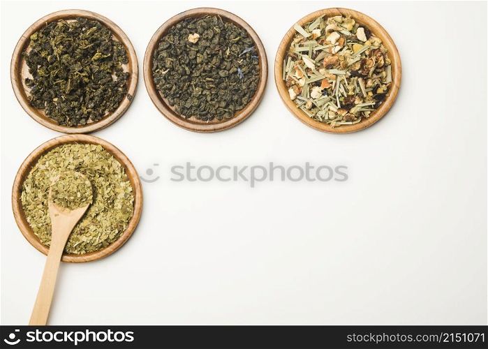 various assorted natural medical dried herbs wooden tray