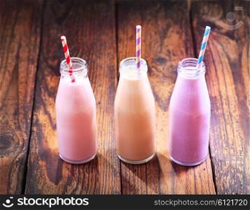 various bottles of fruit smoothie on wooden table