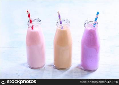 various bottles of fruit smoothie on wooden table