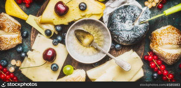 Various Cheese plate with honey dip ,berries and buns, top view, banner