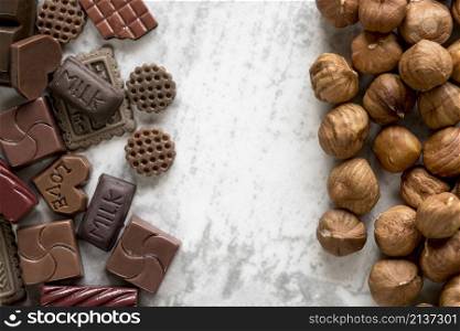 various chocolate blocks hazelnuts white background