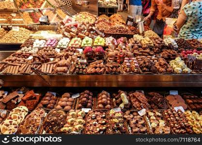 Various chocolate desserts for sale at a shop in the La Boqueria market. Barcelona, Spain.