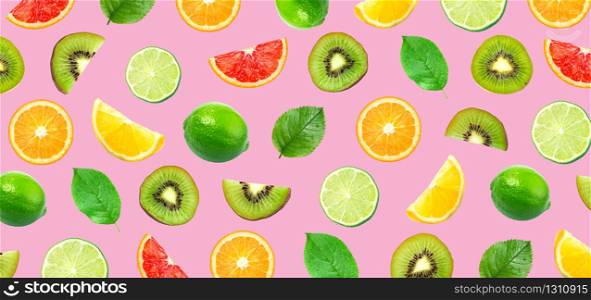 various citrus and kiwi fruits isolated on pink background, top view