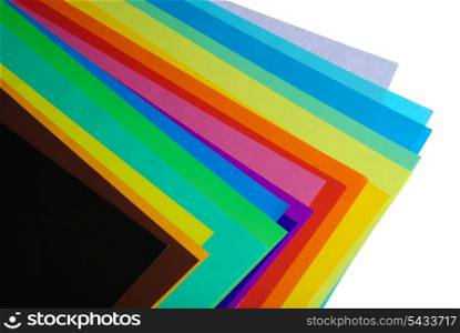various color paper stack like a rainbow isolated on white