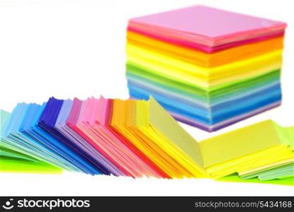 various color paper stack like a rainbow isolated on white. shallow deep of field