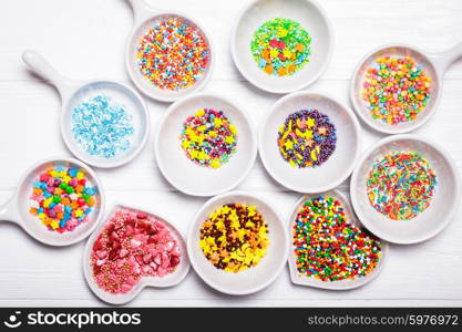 Various color sprinkles in a white bowls. color sprinkles