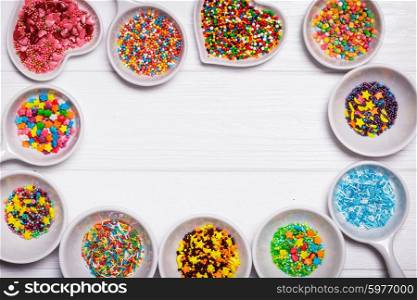 Various color sprinkles in a white bowls. color sprinkles