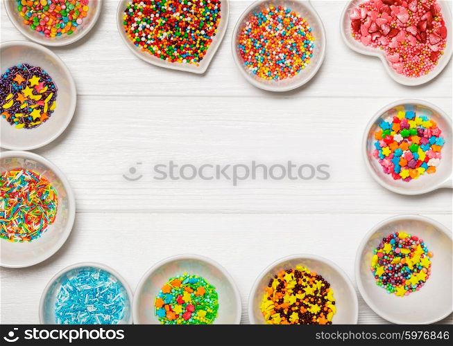 Various color sprinkles in a white bowls - frame with copy space. color sprinkles