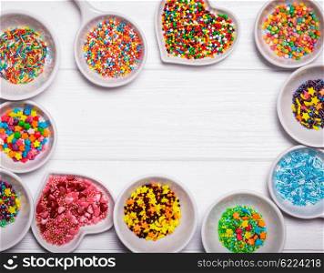 Various color sprinkles in a white bowls. The color sprinkles