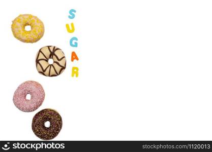 various colored delicious donuts on white background, with the word sugar space for text Fastfood sweet concept. various colored delicious donuts on white background with the word sugar, space for text