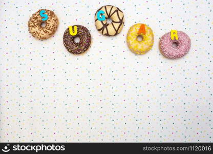 Various colored delicious donuts with festive star background Celebration concept. Top view space for text background party concept. Various colored delicious donuts with festive star background Celebration concept. Top view space for text background