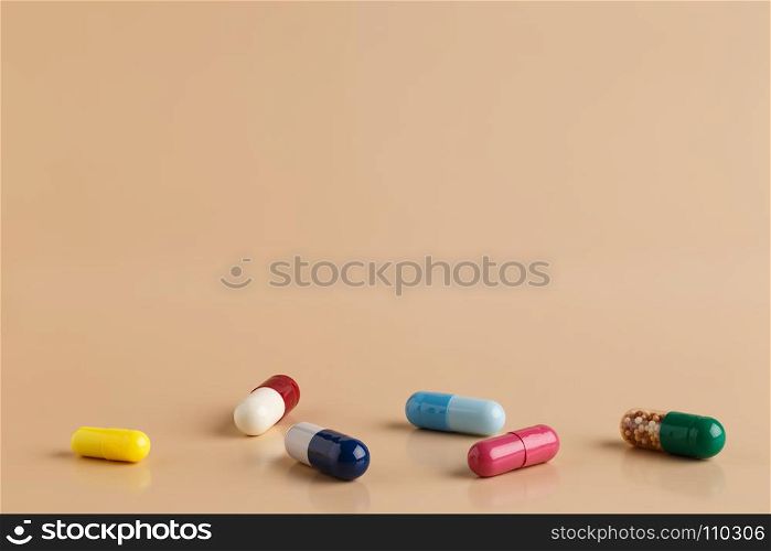 Various colorful pills and capsules. Various colorful pills and capsules on beige background