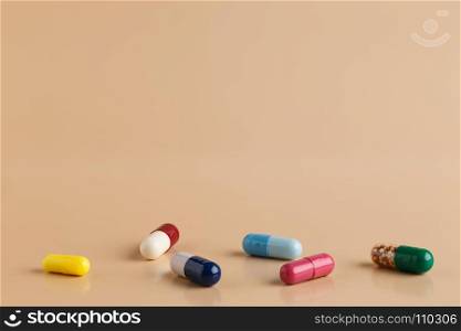 Various colorful pills and capsules. Various colorful pills and capsules on beige background