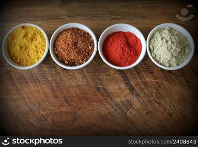 Various colorful spices on wooden table . Top view .. Various colorful spices on wooden table. Top view