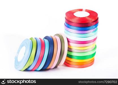Various colors ribbon bobbins isolated on white. The ribbons isolated on the white background