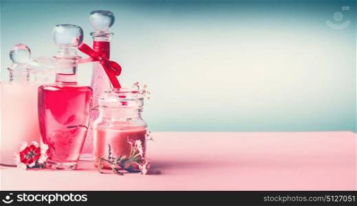 Various cosmetic skin , hairs and body care products in bottles on pink turquoise blue background, front view, place for text, banner, copy space