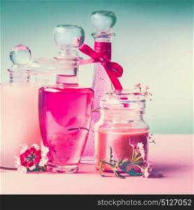Various cosmetic skin , hairs and body care products in bottles on pink turquoise blue background, front view, place for text, square, copy space