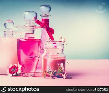 Various cosmetic skin , hairs and body care products in bottles on pink turquoise blue background, front view, place for text, copy space