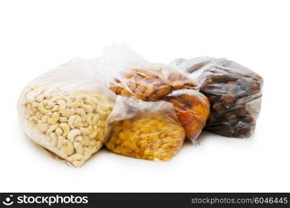 Various dry fruits in the bags on white