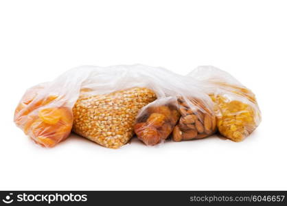 Various dry fruits in the bags on white