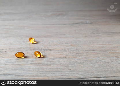 Various fish oil pills capsules on bright table. Various fish oil pills D3 on bright background