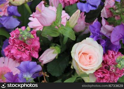 Various flowers in a mixed pink floral arrangement