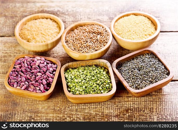 various food ingredients in a bowls on wooden table