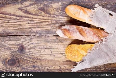 various fresh bread on a wooden table