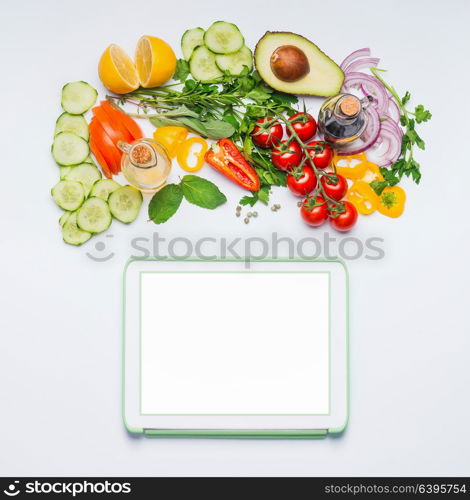 Various fresh organic vegetables for tasty summer salad and tablet mock up on white background, top view. Modern cooking, eating and dieting concept. Blog or online shopping layout