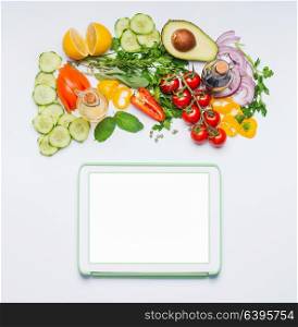 Various fresh organic vegetables for tasty summer salad and tablet mock up on white background, top view. Modern cooking, eating and dieting concept. Blog or online shopping layout