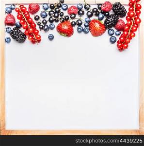 Various fresh summer berries on white tray background, top view, place for text