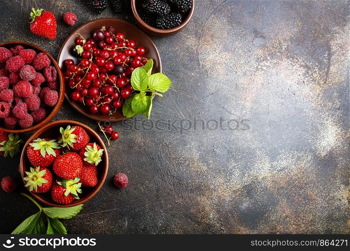 Various fresh summer berries, ripe strawberries, raspberries, blackberry