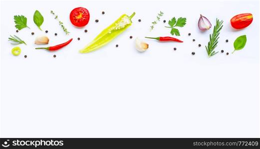 Various fresh vegetables and herbs on white background with copy space. Healthy eating concept