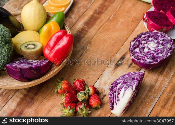 Various fruits with vegetable on wood background