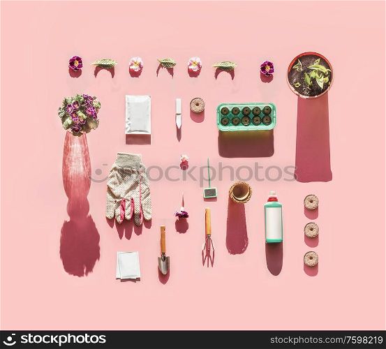 Various gardening tools in sunlight with plant seed bags, fertilization bottle, flowers pots, garden sign and peat seedling tablets on pink background. Top view. Pattern. Flat lay. Branding mock up.