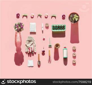 Various gardening tools in sunlight with plant seed bags, fertilization bottle, flowers pots, garden sign and peat seedling tablets on pink background. Top view. Pattern. Flat lay. Branding mock up.
