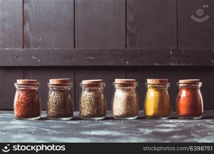 Various grinded spices in vintage glass bottles. Various grinded spices