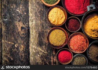 Various ground spices and herbs. On a wooden background.. Various ground spices and herbs.