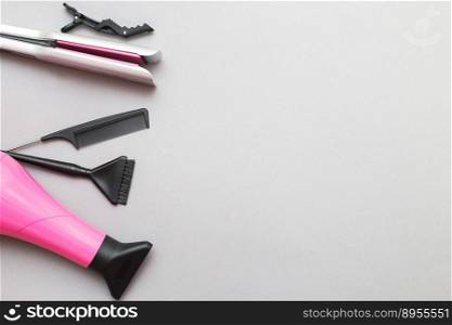 various hairdressing tools like hair dryer, comb on a gray background. beauty salon concept.. various hairdressing tools like hair dryer, comb on a gray background. beauty salon concept