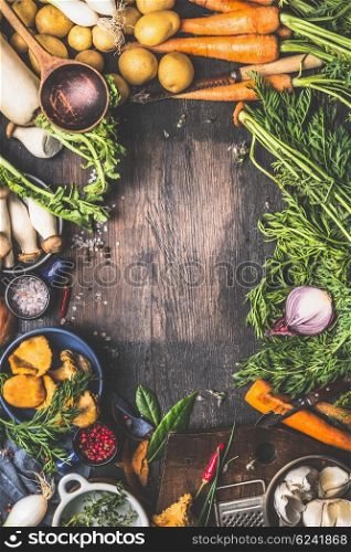 Various harvest Vegetables from garden and forest mushrooms. Vegetarian ingredients for cooking on dark rustic wooden background, frame, top view