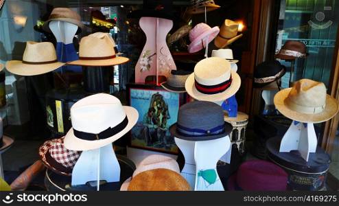 Various hats in a store window.